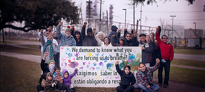 People with "we demand to know" banner
